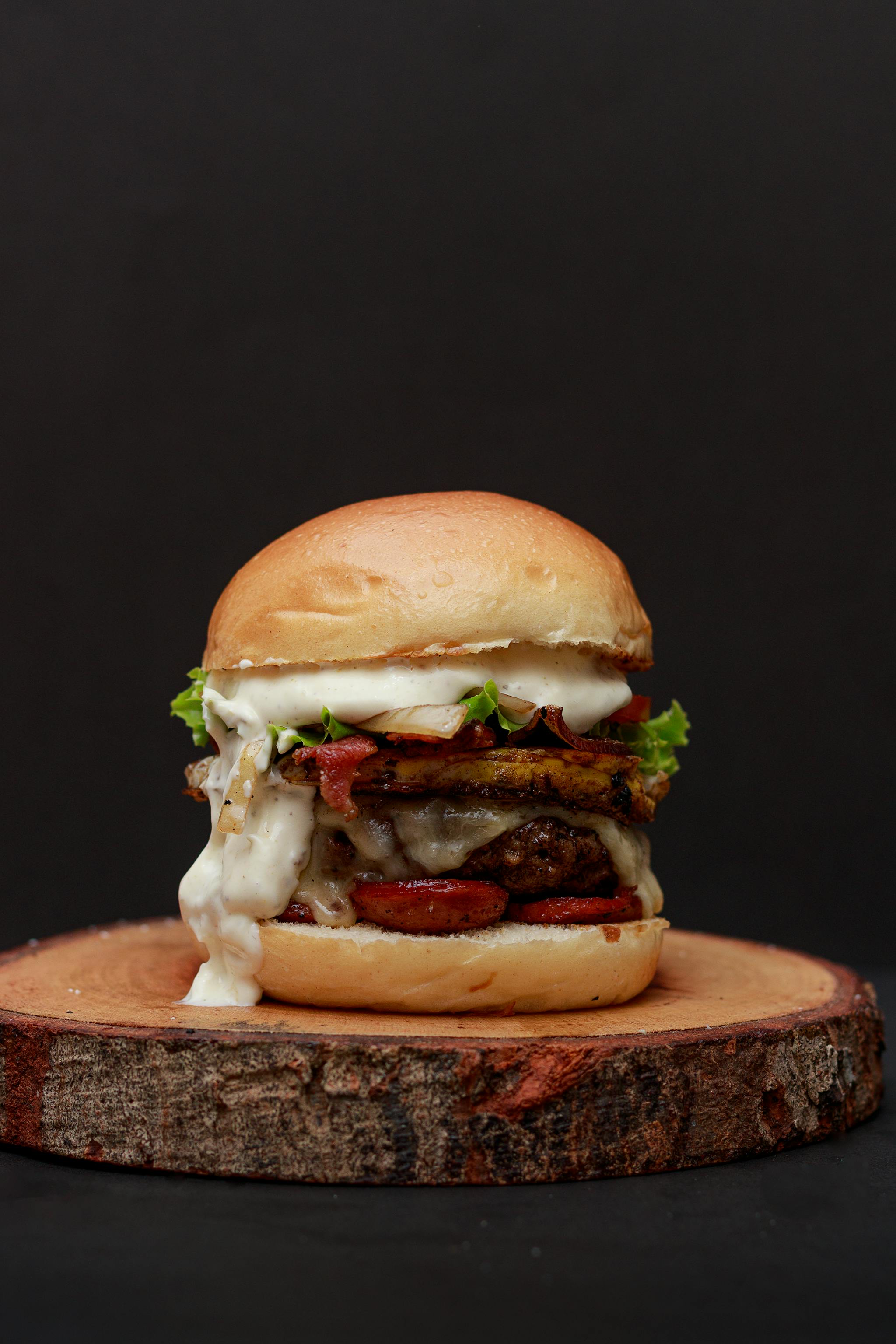 The Barn Classic — double smash burger with American cheese and pickles on a brioche bun